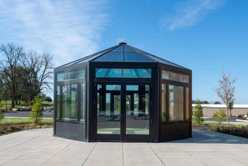a black greenhouse with glass doors on a sidewalk at Wyndham Lancaster Resort and Convention Center in Lancaster