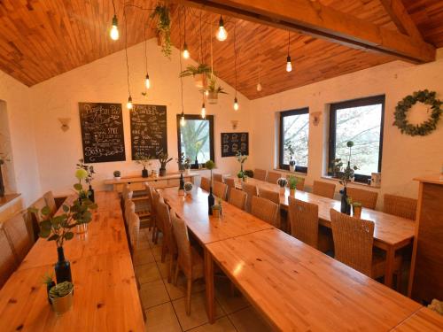 a large dining room with wooden tables and chairs at Spacious Holiday Home in Vielsalm with Garden in Vielsalm