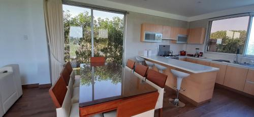 a kitchen with a counter and a large window at Elysium Farmland in Blas Herrera