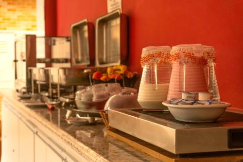 a kitchen with a counter with bowls and utensils at UPG Hotel in Ubatuba
