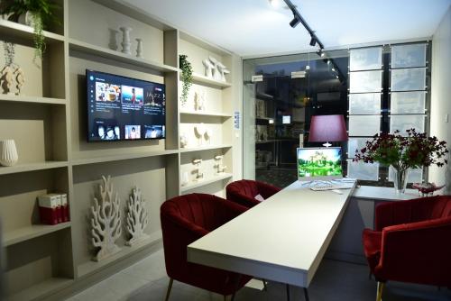 a office with a white desk and red chairs at Levante Holiday Apartments in Larnaca