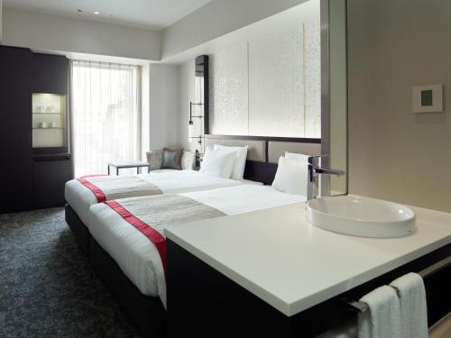 Кровать или кровати в номере Mitsui Garden Hotel Fukuoka Nakasu