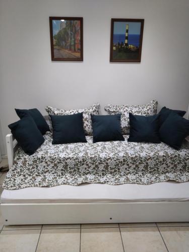 a white couch with black and white pillows on it at Flat beira mar, Olinda 4 Rodas 309 in Olinda