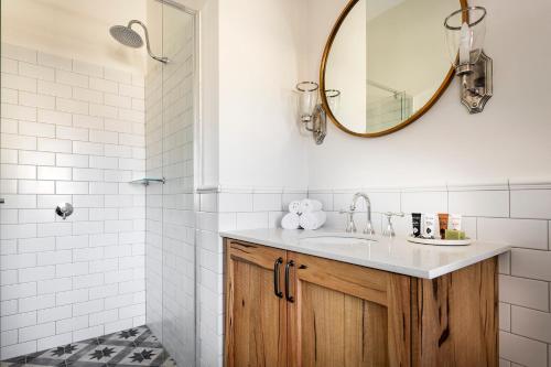 a bathroom with a sink and a mirror at The National Hotel in Fremantle