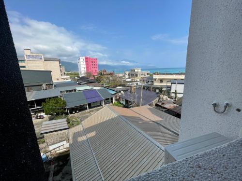 a view of a city from the balcony of a building at 七星潭118海景民宿 in Dahan