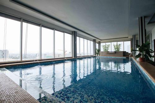 a swimming pool in a building with large windows at Northpointe Residences in Manila