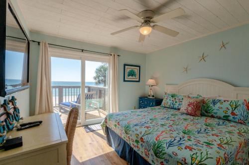 a bedroom with a bed and a view of the ocean at Sunny Beach by Book That Condo in Panama City Beach