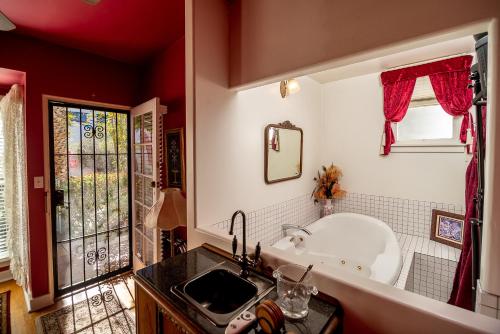 a bathroom with a bath tub and a sink at The Blenman Inn in Tucson