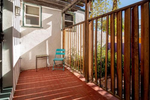 a blue chair sitting on a porch with a fence at The Blenman Inn in Tucson