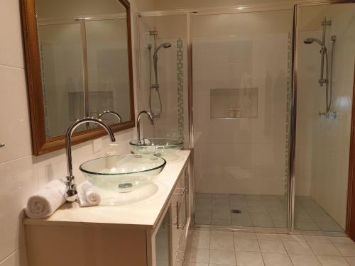a bathroom with two sinks and a shower at Limpinwood Lodge in Limpinwood