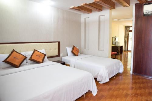 Ho May Resort tesisinde bir odada yatak veya yataklar