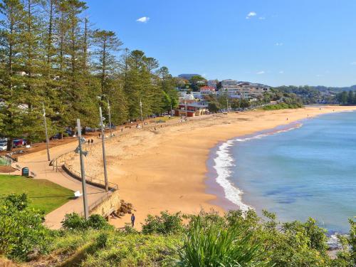 a view of a beach with people on it at Cosy Studio With Deck, Close to Shops and Beach in Terrigal