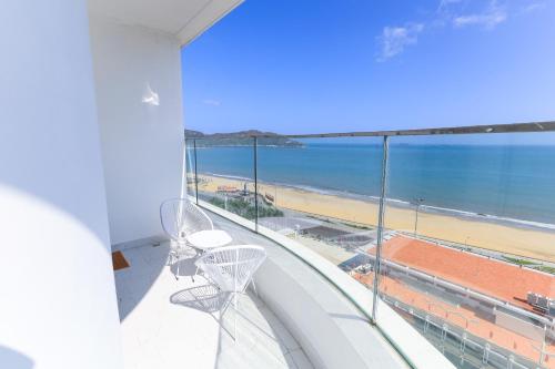 a balcony with two chairs and a view of the beach at TMS-PULLMAN MINH MINH Apartment in Quy Nhon