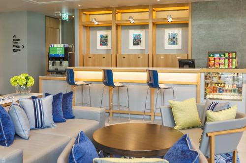 a bar with couches and a table and chairs at Holiday Inn Express Bangkok Sathorn by IHG in Bangkok
