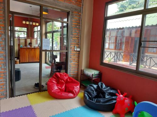 a room with two bean bag chairs and a window at Pilgrim's Kitchen & Inn in Savannakhet