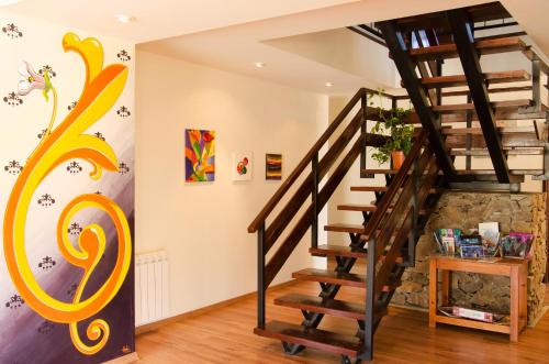 a spiral staircase in a home with a wall at Hostería Los Gnomos in El Calafate