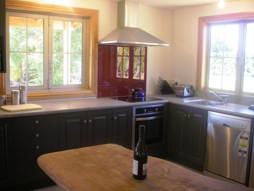 a kitchen with a bottle of wine sitting on a table at Lexi's Lodge in Lake Tekapo