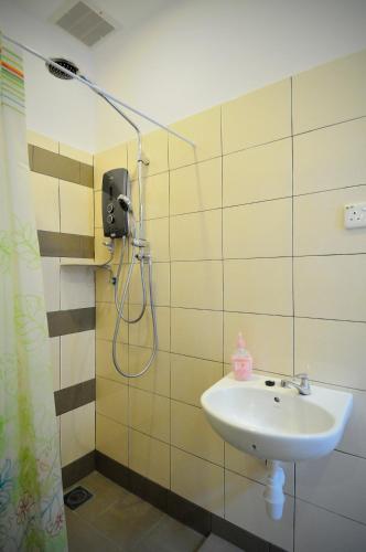 a bathroom with a sink and a shower at Thirty Three Stewart Houze in George Town