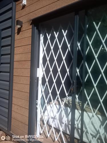 a window with a white lattice screen on a house at Isikhoma-Khoma in Hilton