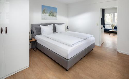 Ένα ή περισσότερα κρεβάτια σε δωμάτιο στο Strandloft Drei Norderney