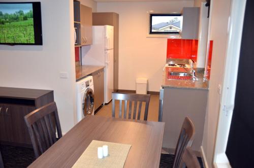 a kitchen and dining room with a table and a kitchen at Hunts Hotel Liverpool in Liverpool
