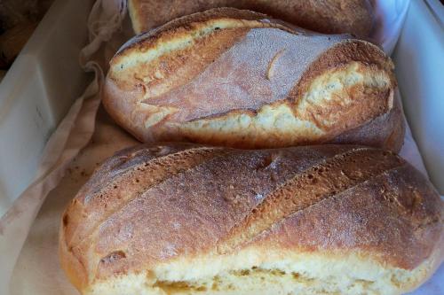 three loaves of bread sitting in a box at Agriturismo Il Pavone in Torre Lapillo