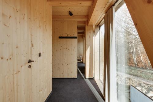 a hallway of a house with wooden walls and a window at Wilcza For Rest in Karpacz