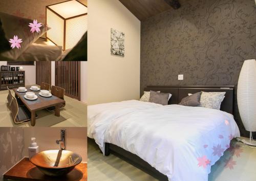 a bedroom with a bed and a table and a room at CASA GRApP Nishikujyo in Osaka