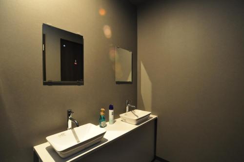 a bathroom with two sinks and a mirror at Rusutsu Grand Cabin in Kimobetsu