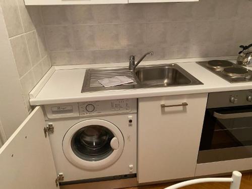 a kitchen with a sink and a washing machine at Corso Italia 4 in Bordighera