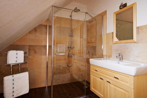 a bathroom with a sink and a shower at Frühstückspension Kleinschuster in Burgau