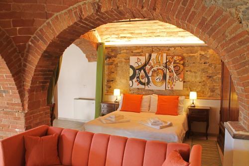 a bedroom with a bed and a brick wall at I Voltoni di Corsignano in Siena