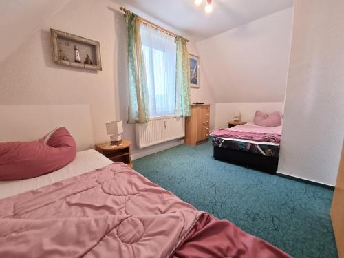 a bedroom with two beds and a window at Ferienhaus Zeus / Seebad Ückeritz / Insel Usedom in Ueckeritz