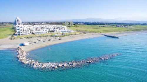 an aerial view of a beach with buildings and the ocean at Aphrodite Beachfront Resort Official in Ghaziveran