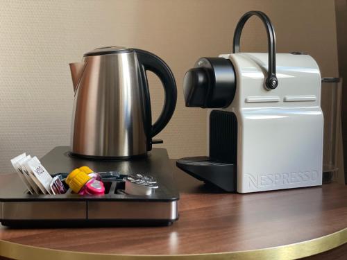 a coffee pot sitting on top of a counter next to a printer at Hotel Chemnitzer Hof in Chemnitz