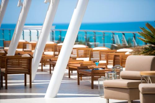 a balcony with chairs and tables on a cruise ship at TUI Blue Barut Andız - All Inclusive - Adults Only in Side