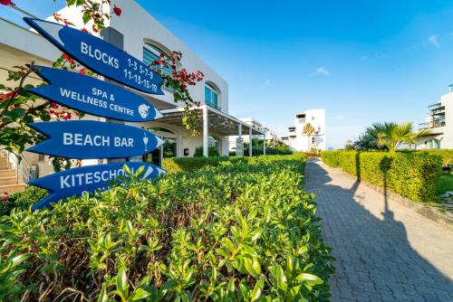 a street sign in front of a beach bar at Aphrodite Beachfront Resort Official in Ghaziveran