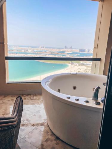 a bath tub in a bathroom with a view of the ocean at JBR Jumeirah beach SADAF6 sea view in Dubai