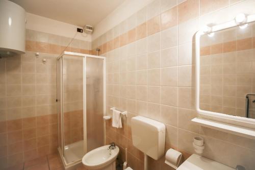 a bathroom with a shower and a toilet and a sink at BETULLE Lido Altanea in Caorle