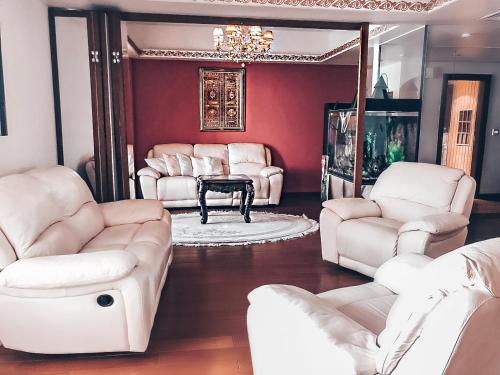 a living room with white chairs and a table at JBR Jumeirah beach SADAF6 sea view in Dubai