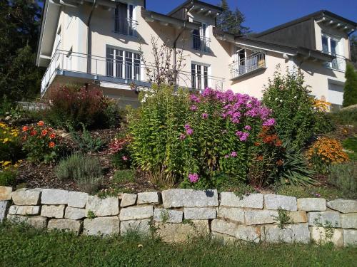 a garden in front of a house with flowers at Ferienwohnung Anita Benz in Thurmansbang