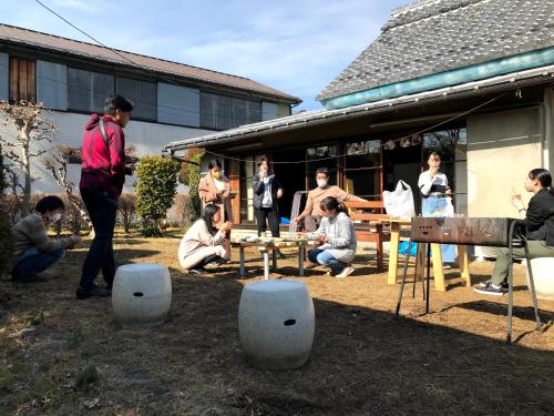 a group of people playing a game in a yard at Guest House Yukari in Tsuru 