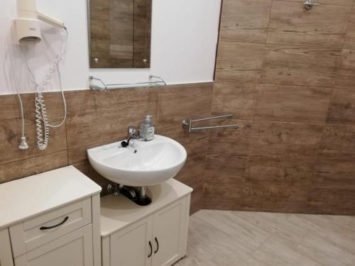 a bathroom with a white sink and a mirror at Vivi holiday house for 4 people in Nerezine