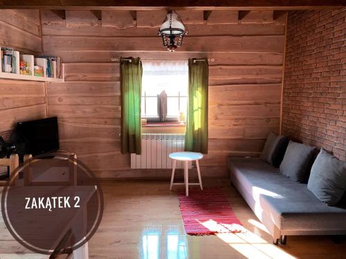 a living room with a couch and a table at Chata Starych Znajomych in Sanok