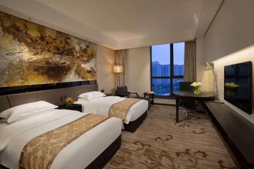 a hotel room with two beds and a large window at Ramada by Wyndham Xian Long march in Jixian