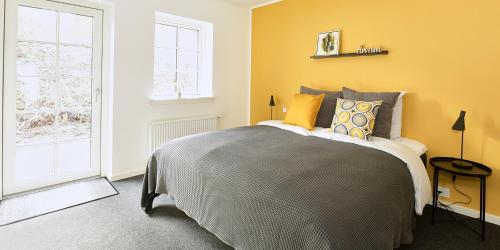 a bedroom with a bed and a window at Hotel Skovpavillonen in Kerteminde
