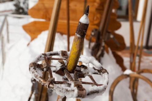 a stick in a snow covered chair at Ciasa Roby in San Cassiano