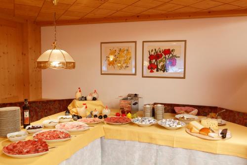 a table with plates of food on it at Ciasa Roby in San Cassiano