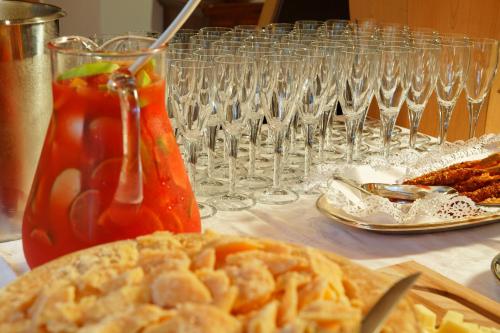 a table with wine glasses and a plate of food at Ciasa Roby in San Cassiano