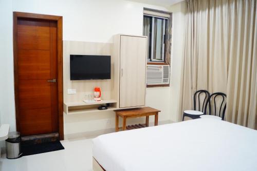 a hotel room with a bed and a tv at Hotel Shree Shyam International in Bilāspur